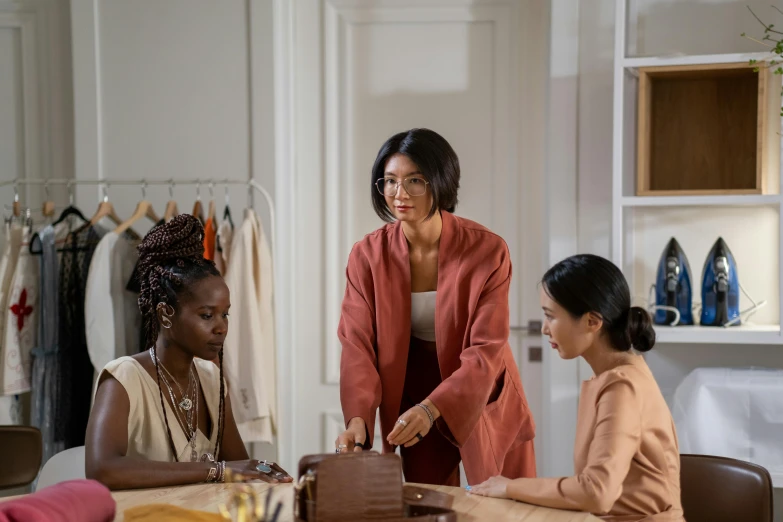 three women having conversation in an office