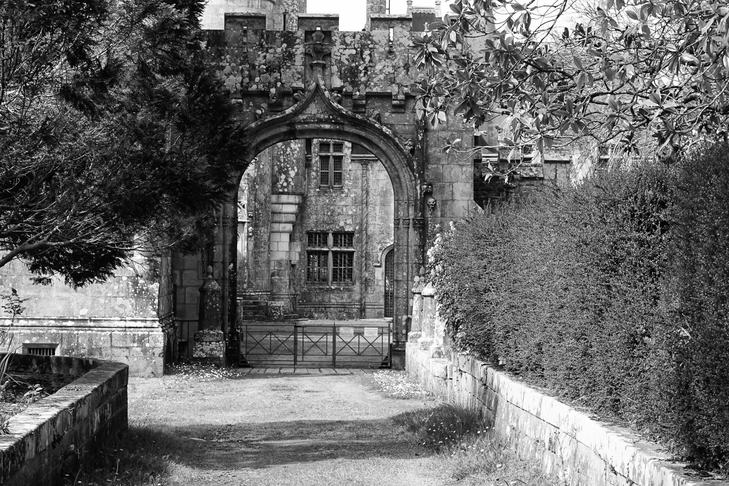 a black and white po of a gate between two buildings