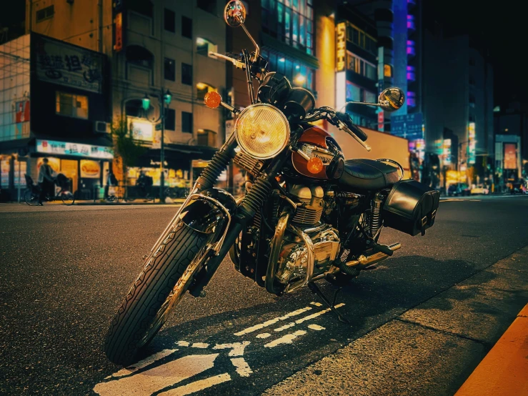 a motor bike parked on the side of the road in front of the buildings