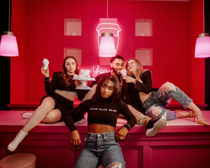 a group of young people siting on top of a bench