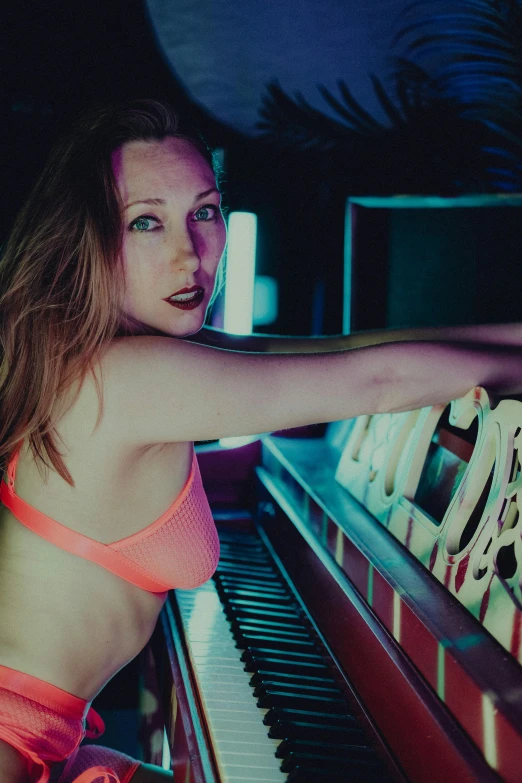 girl in bikini top sitting near an organ