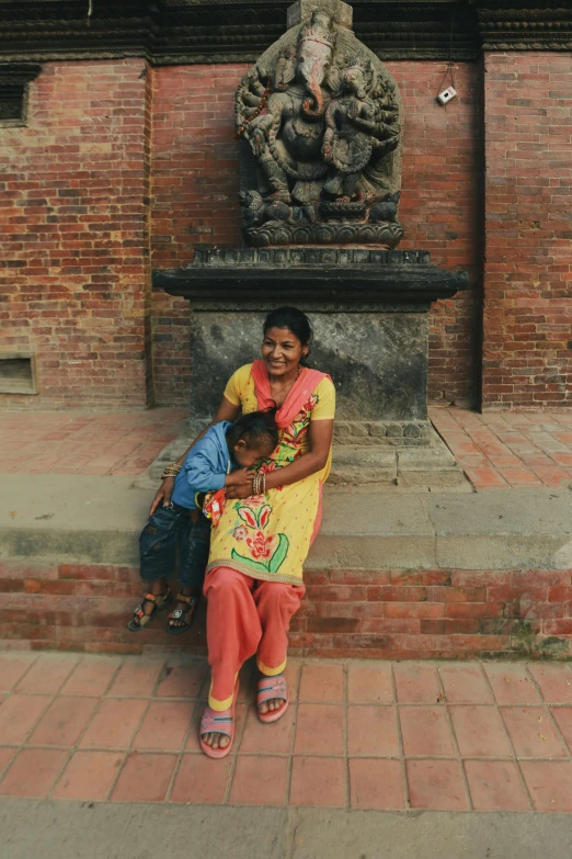 a woman and her child sitting on a step