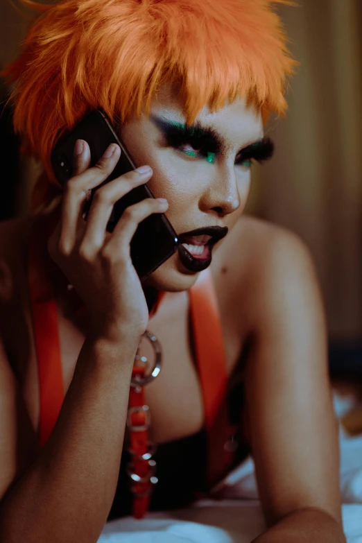 a woman with red hair is talking on a cell phone