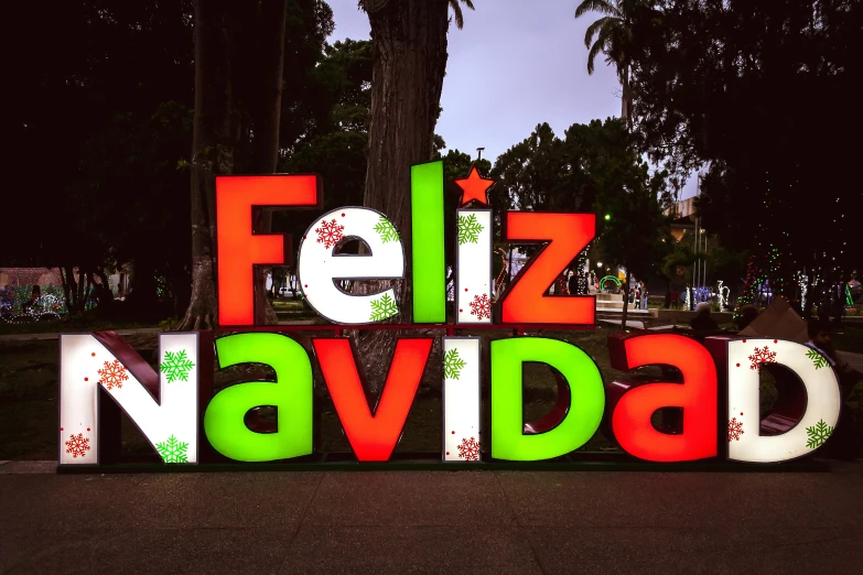 a glowing sign on a sidewalk for the holiday season