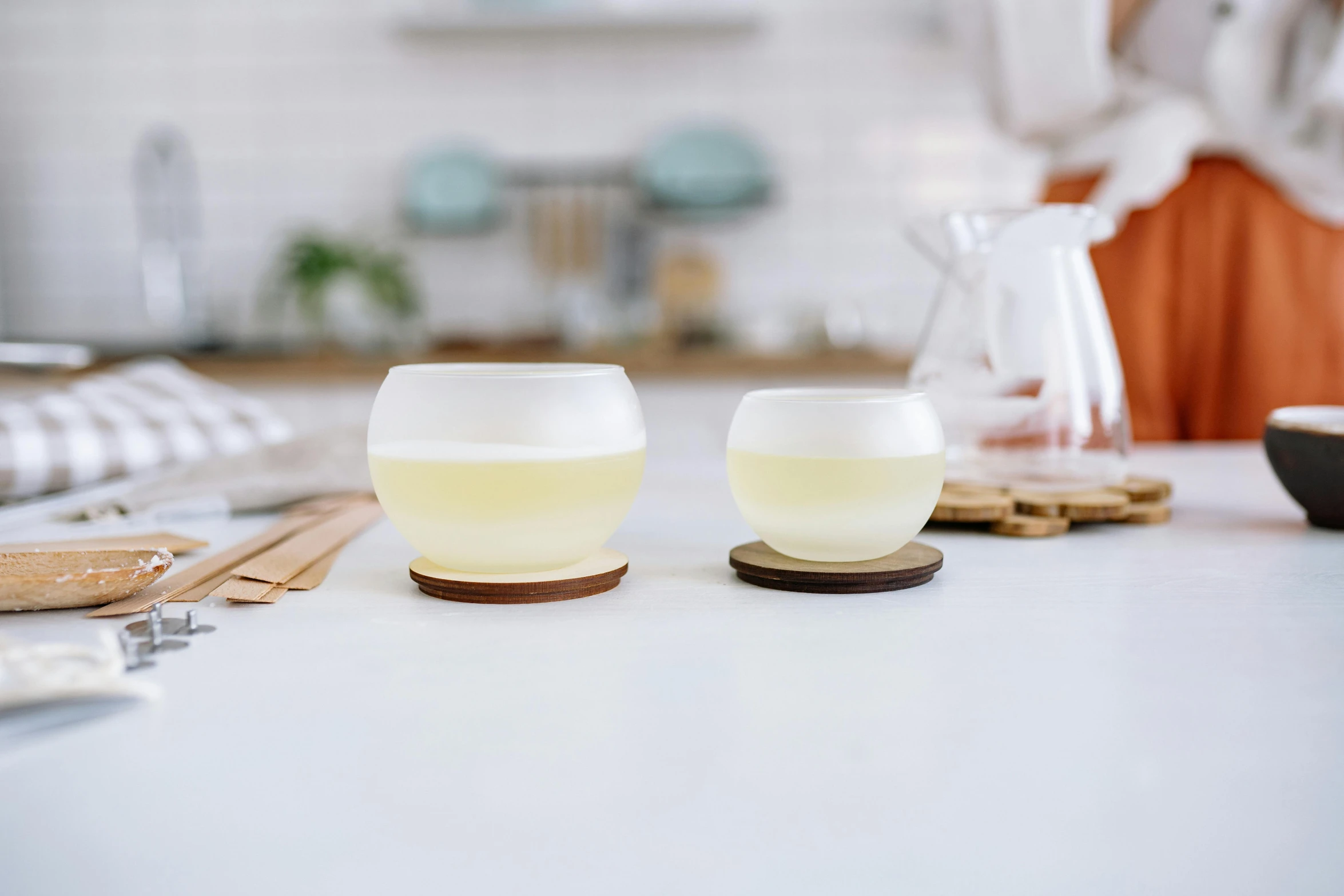 a woman standing at a counter with some plates