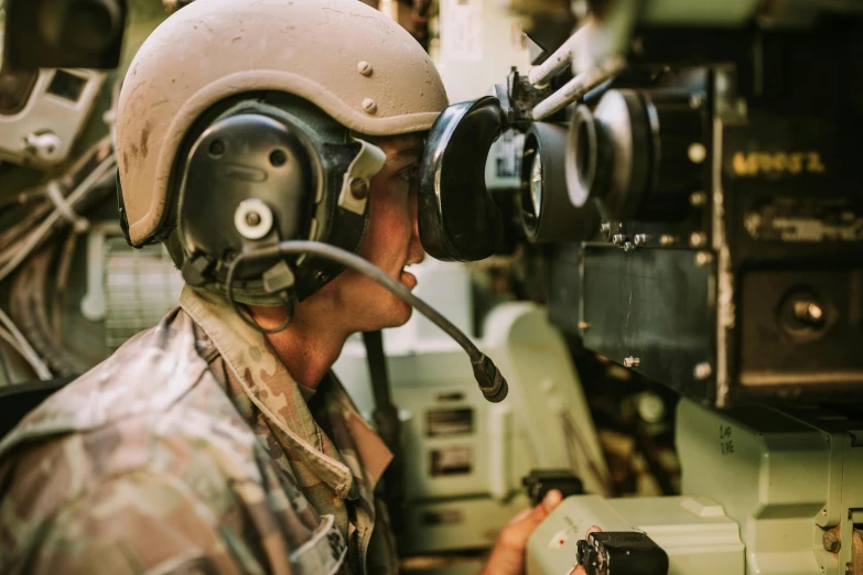 a man in military uniform talking on a radio