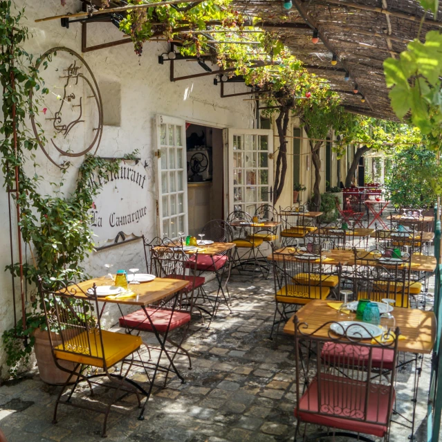 a row of tables set for lunch outside an cafe