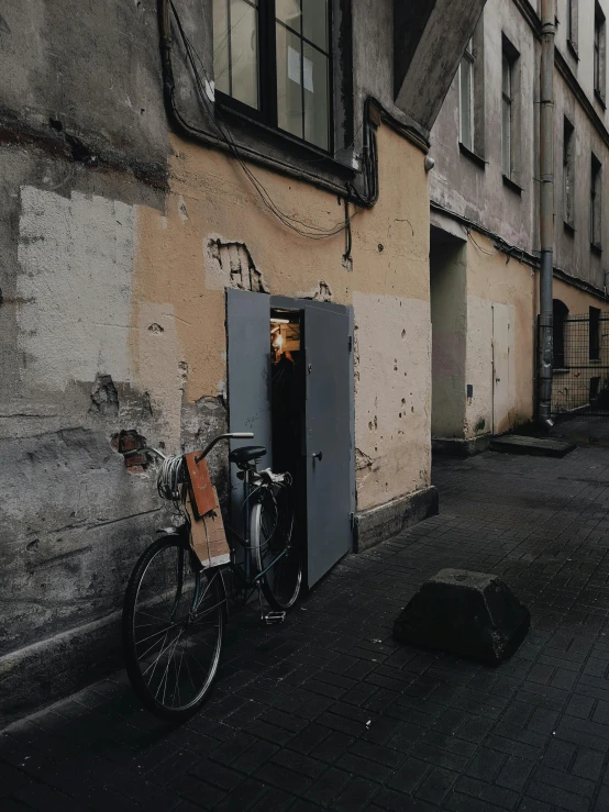 two bicycles are parked in a doorway on a city street