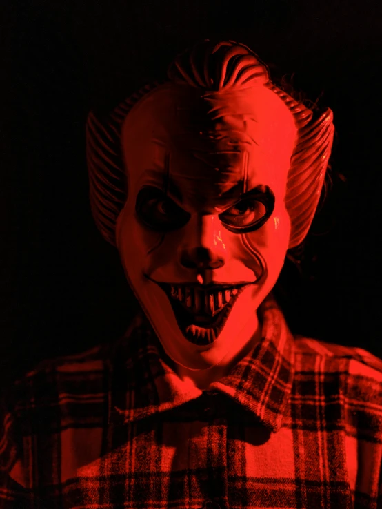 a creepy clown's face wearing a plaid shirt