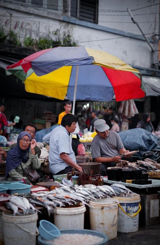 an outdoor market selling food and drinks in buckets