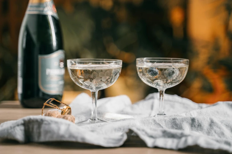 two glasses filled with different types of wine and two bottles