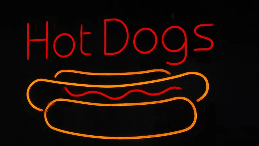 a  dog with ketchup and relish neon sign