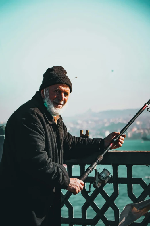 a man is fishing on a bridge by the water