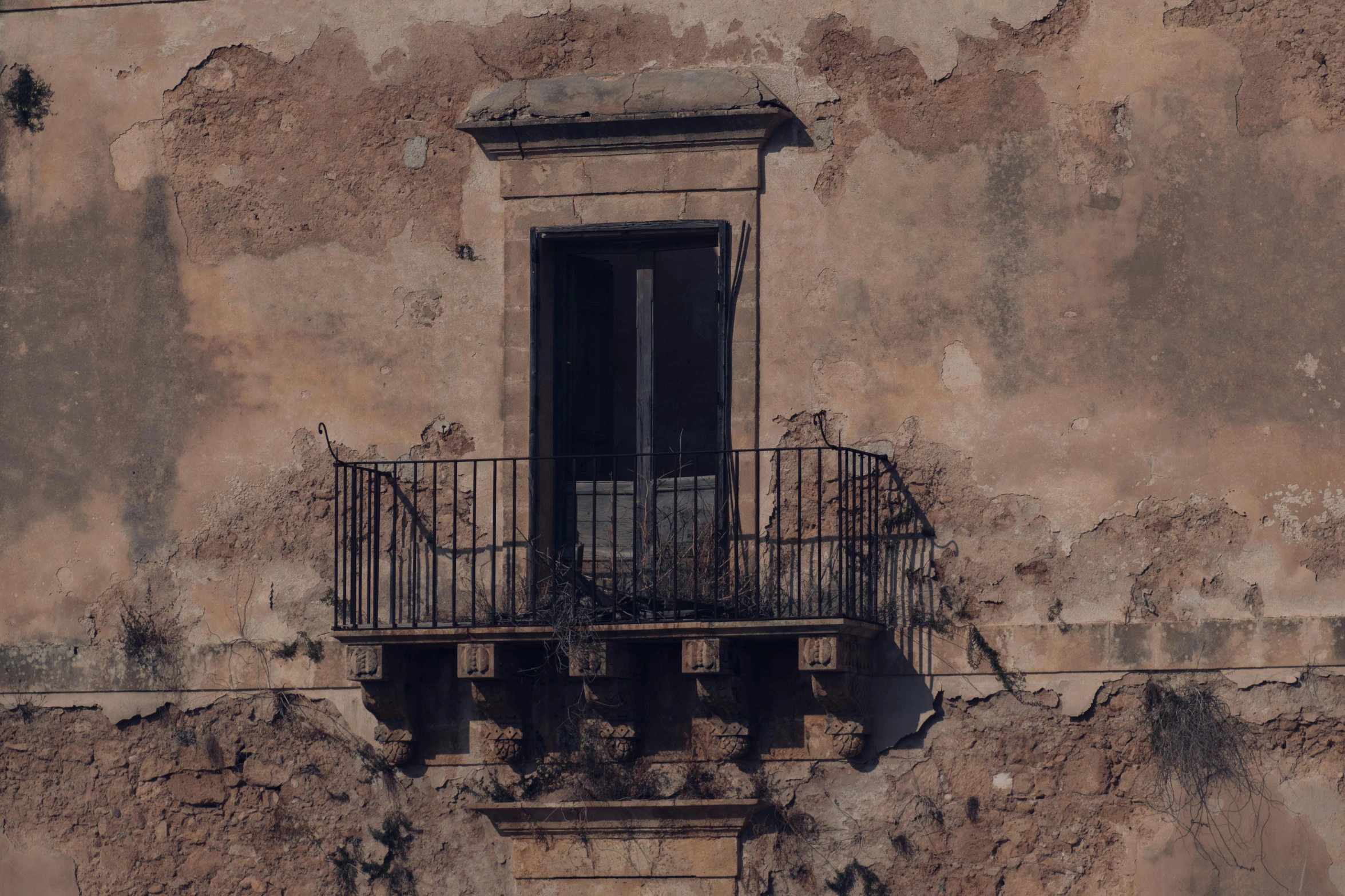 an old building with a wrought iron balcony