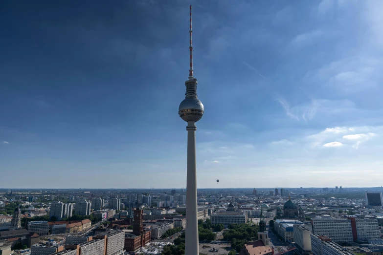 a tall tower towering over a city next to a river