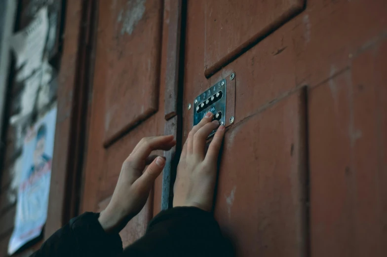 someone holding a door handle near the door