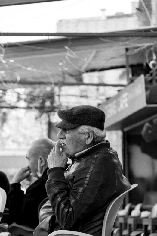 an older man talks on the phone while a younger woman looks on