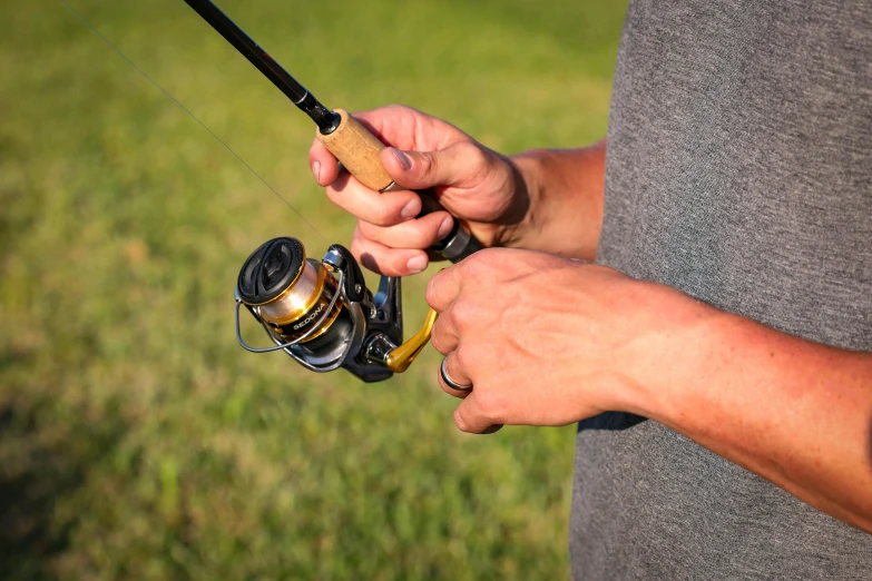 a man holding onto a spinning fishing rod