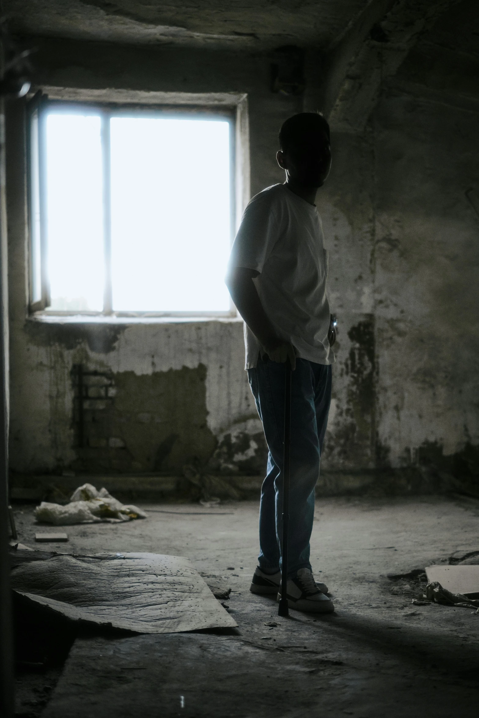 a person standing in a room looking into a window