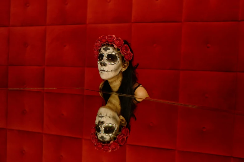 a woman with skeleton makeup and makeup in a mirror