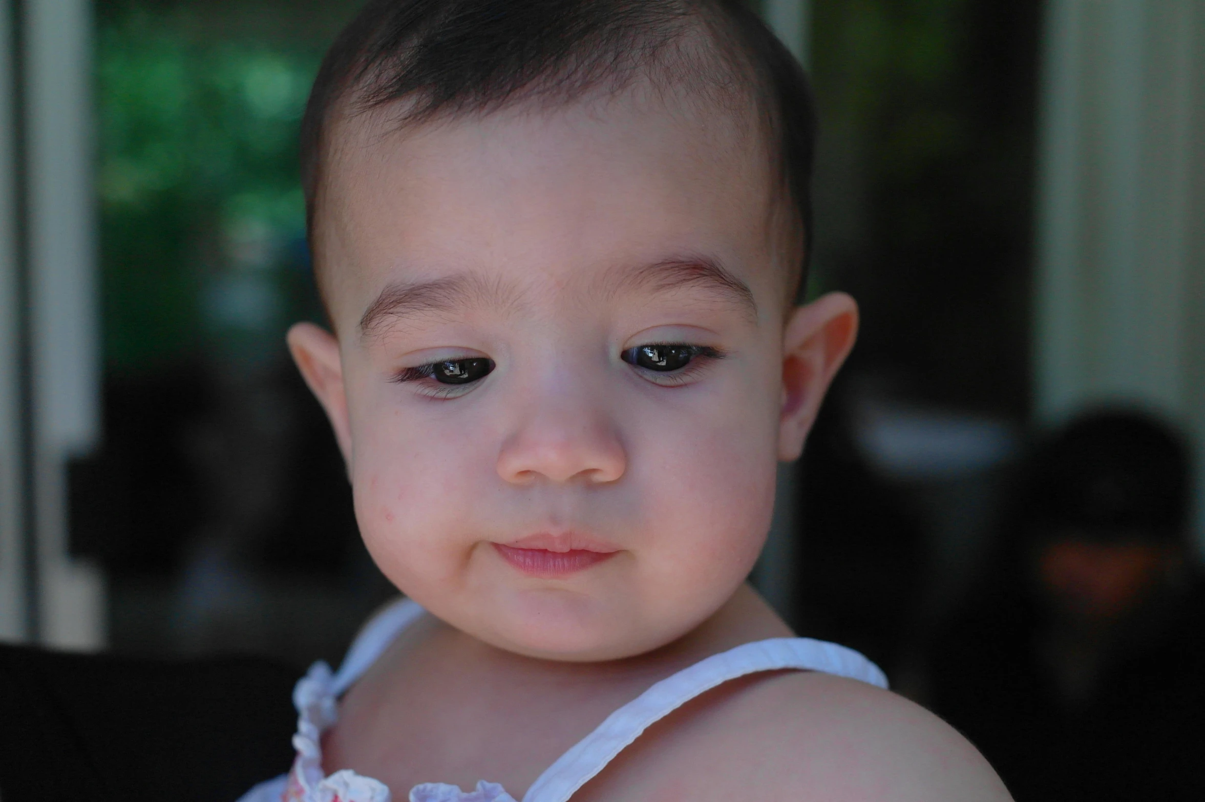 a young child wearing a pink flowered dress