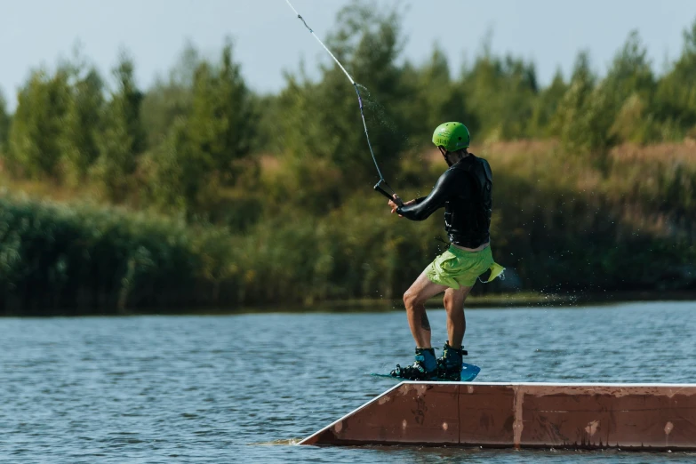 the man is on a dock with his fishing pole