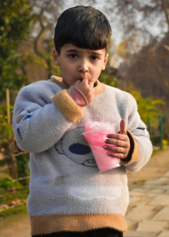 a  holding a pink cup in his hand