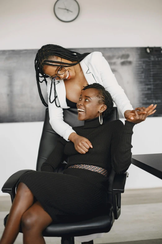 an african american lady and a black woman in an office setting