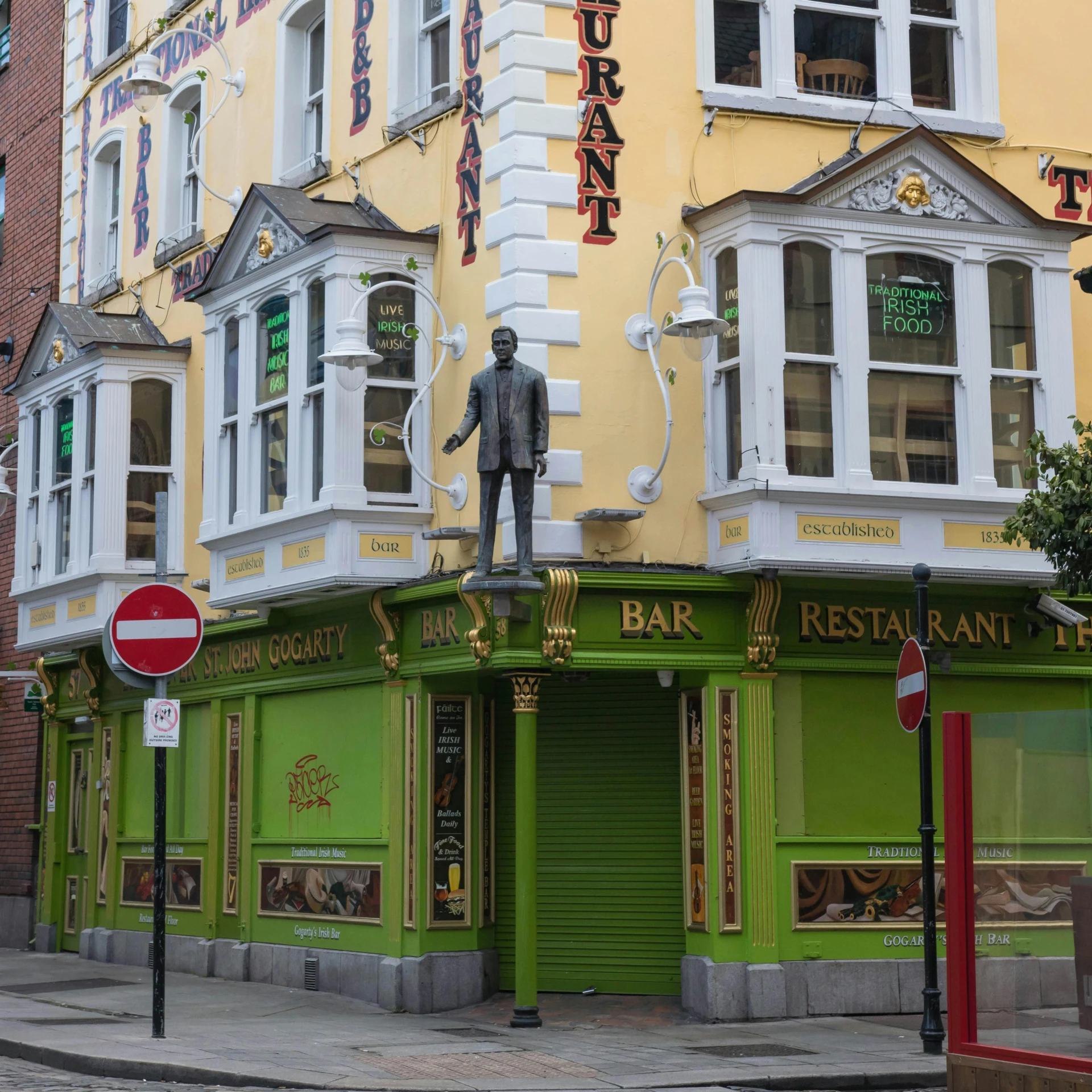 the restaurant sign is in english on the corner of the street