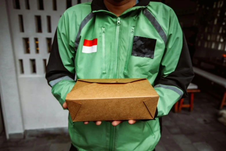 a person is holding a box with a german flag on it