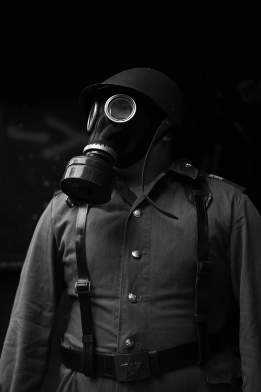 a soldier with a gas mask is standing in the dark