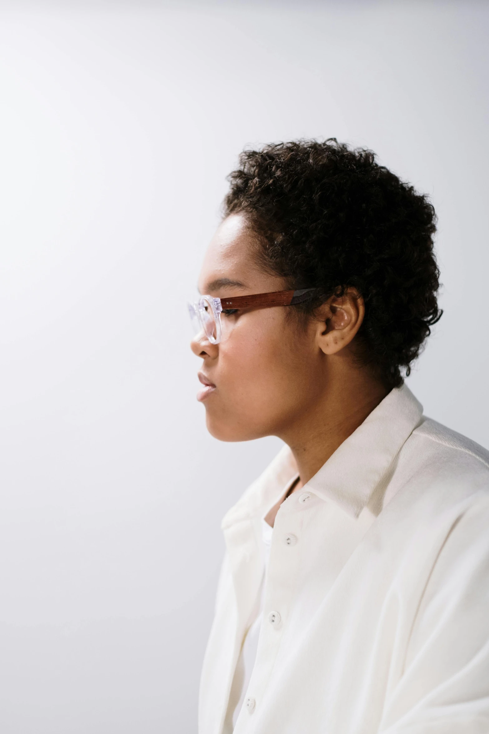 a woman is wearing glasses and looking away