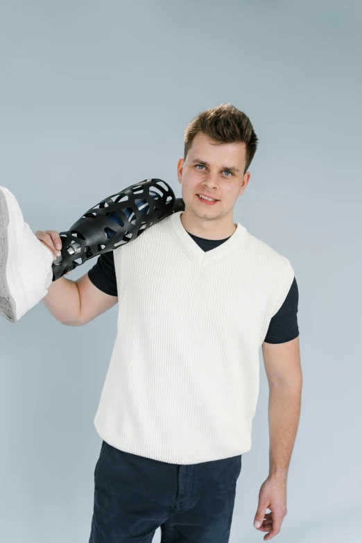 a man holding onto a baseball bat and gloves