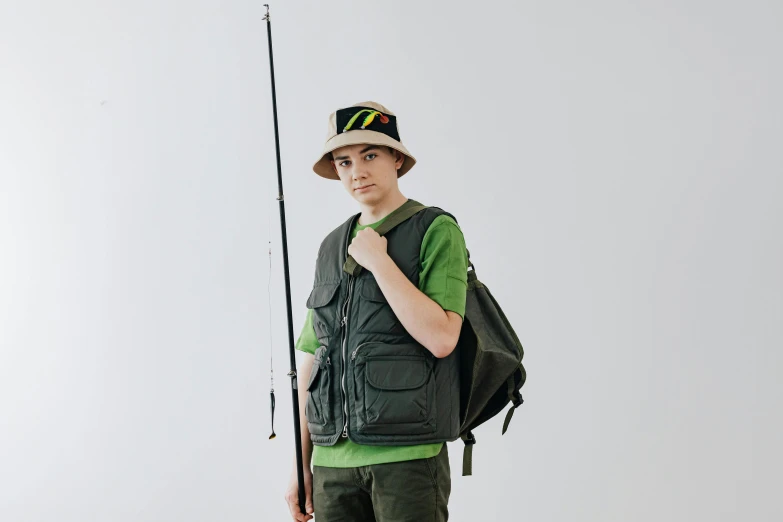 a man with a backpack and fishing pole