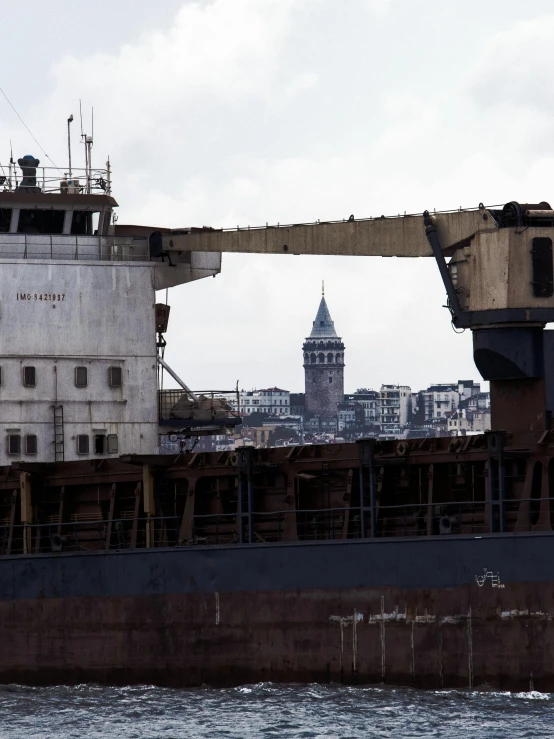 old, rusty large boat in harbor with view of big ben