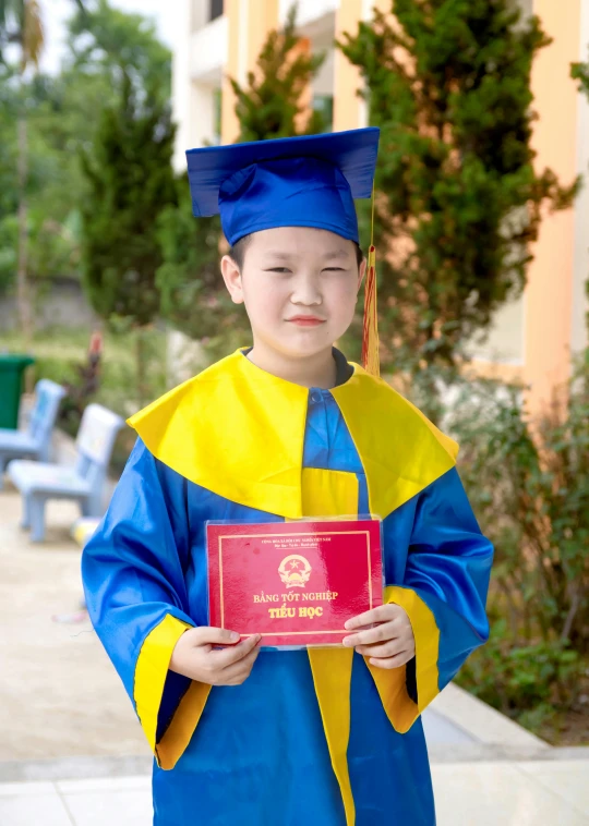 an asian  dressed up in graduation gown