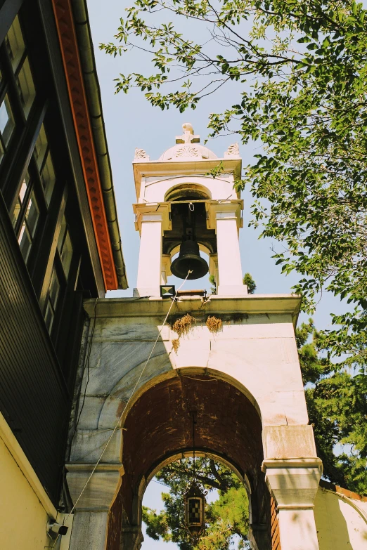 an arched doorway opens up into a bell tower