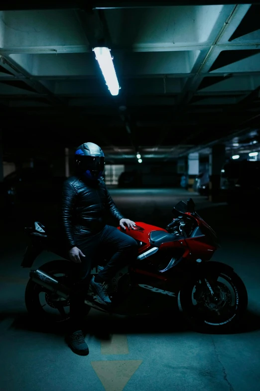 a man is sitting on a motorcycle under the garage