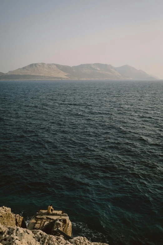 view from a rock looking out at the water