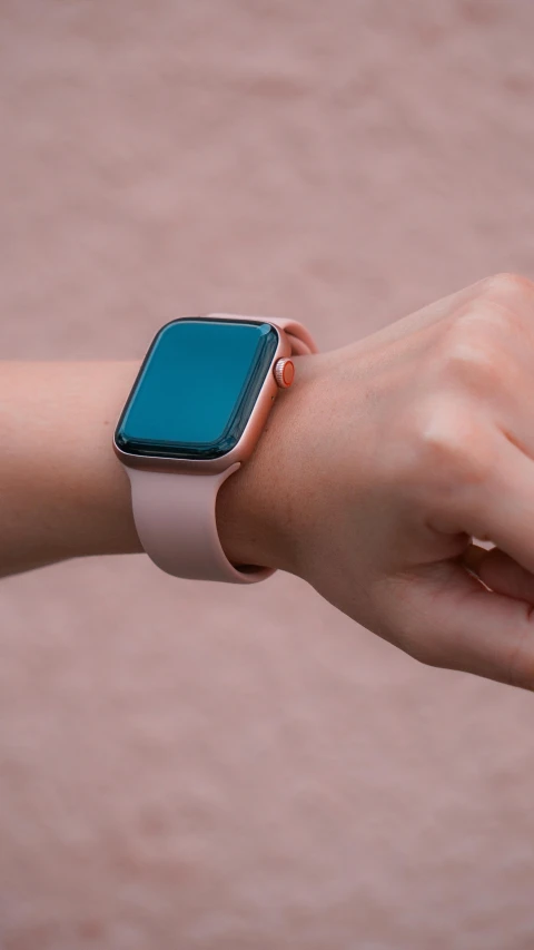 someone holding onto a smart watch on their wrist