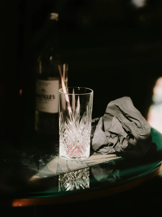 a bottle and some glasses on a table