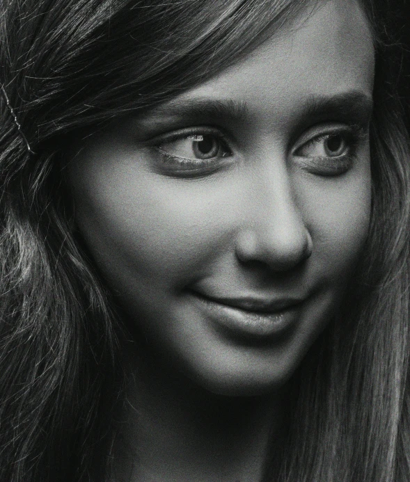 a black and white image of a woman smiling