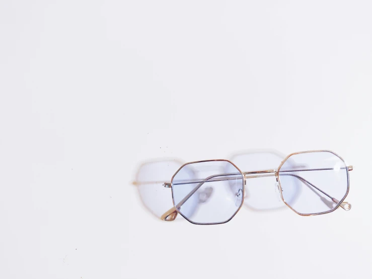 three glasses on a white table next to each other