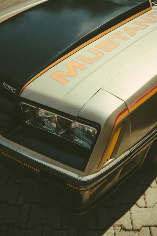 an older black and tan car that is parked