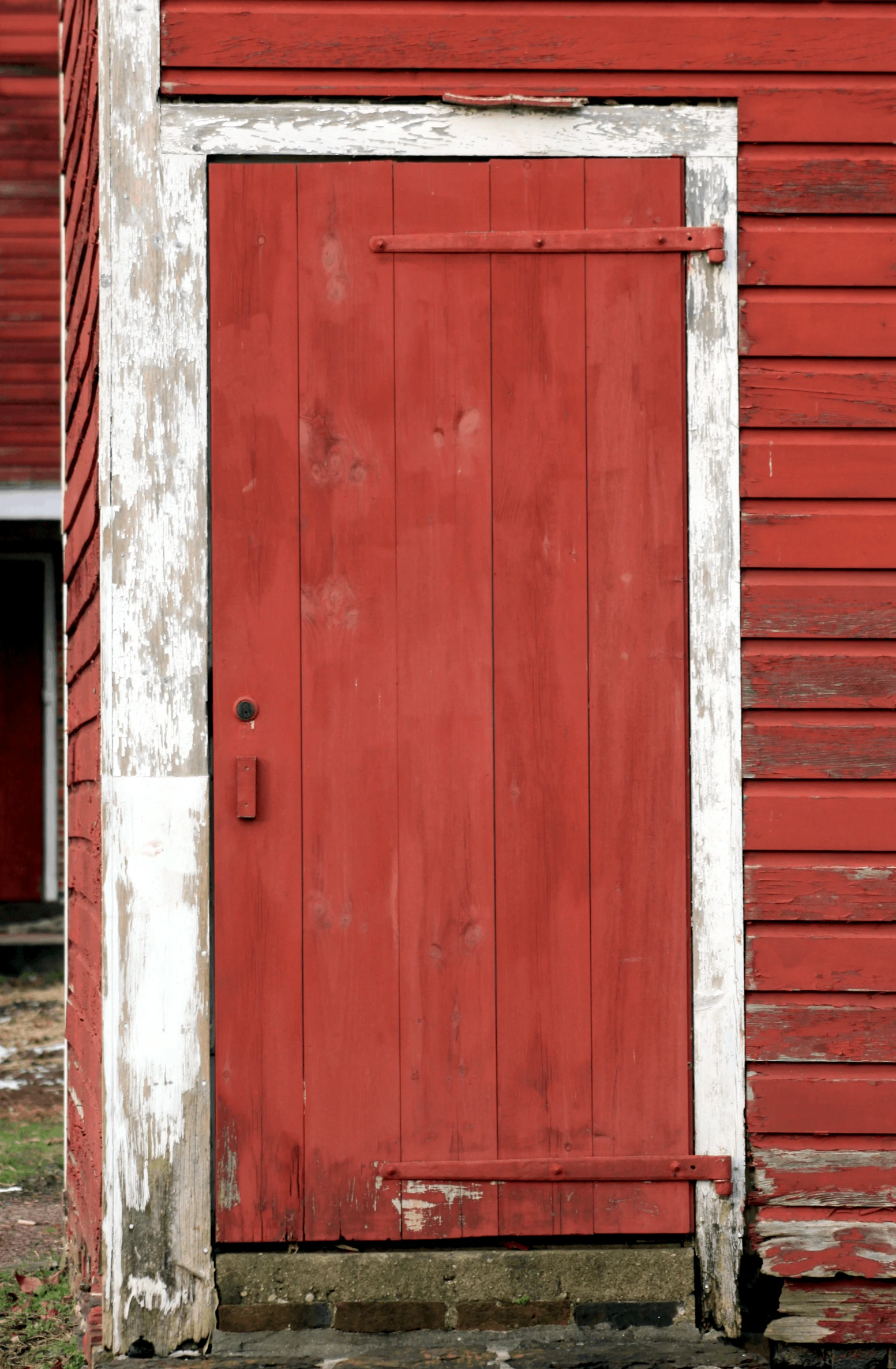 a red door with an open side by side on a white frame