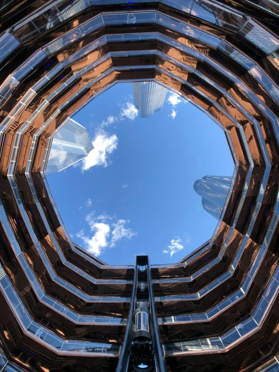 the building has three large curved windows and blue sky