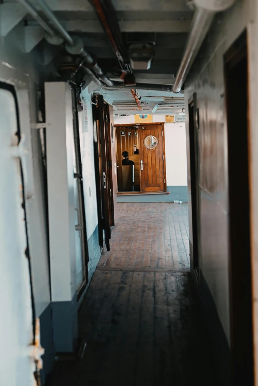 hallway of an abandoned building with a big clock above the door