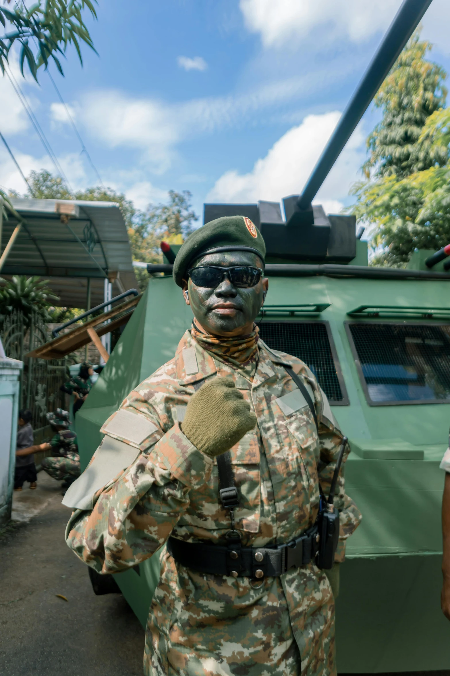 a man in camouflage and military sunglasses wearing goggles