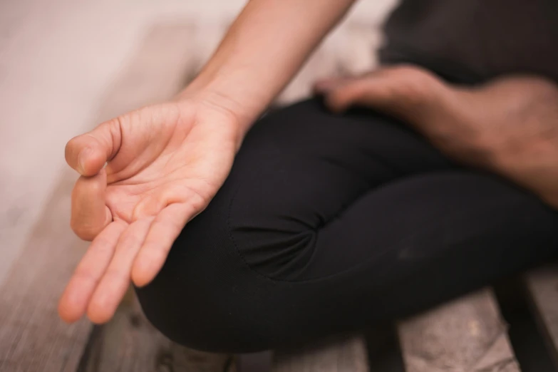 the hands of a woman are outstretched from a bench