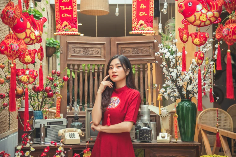 an asian woman standing near the decorations for a wedding